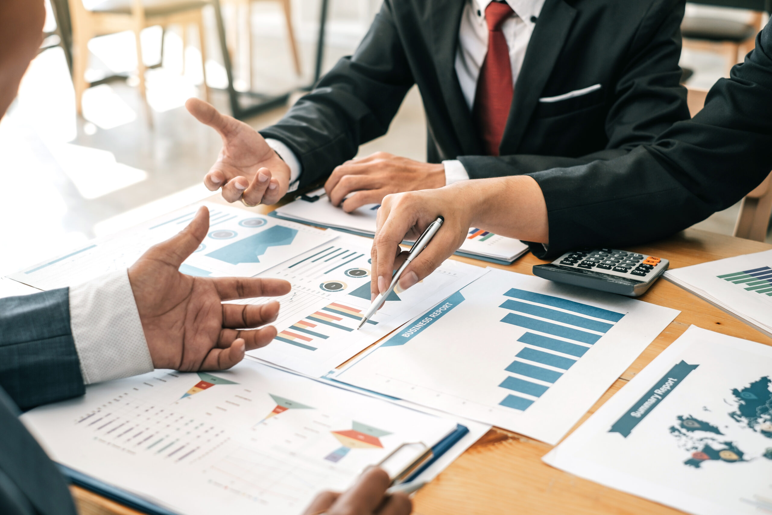 businesspeople evaluating graphs at a conference table